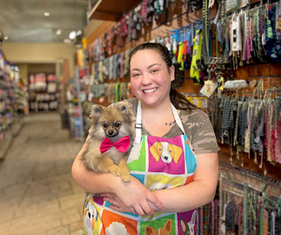 A woman is holding dog in shopping mall